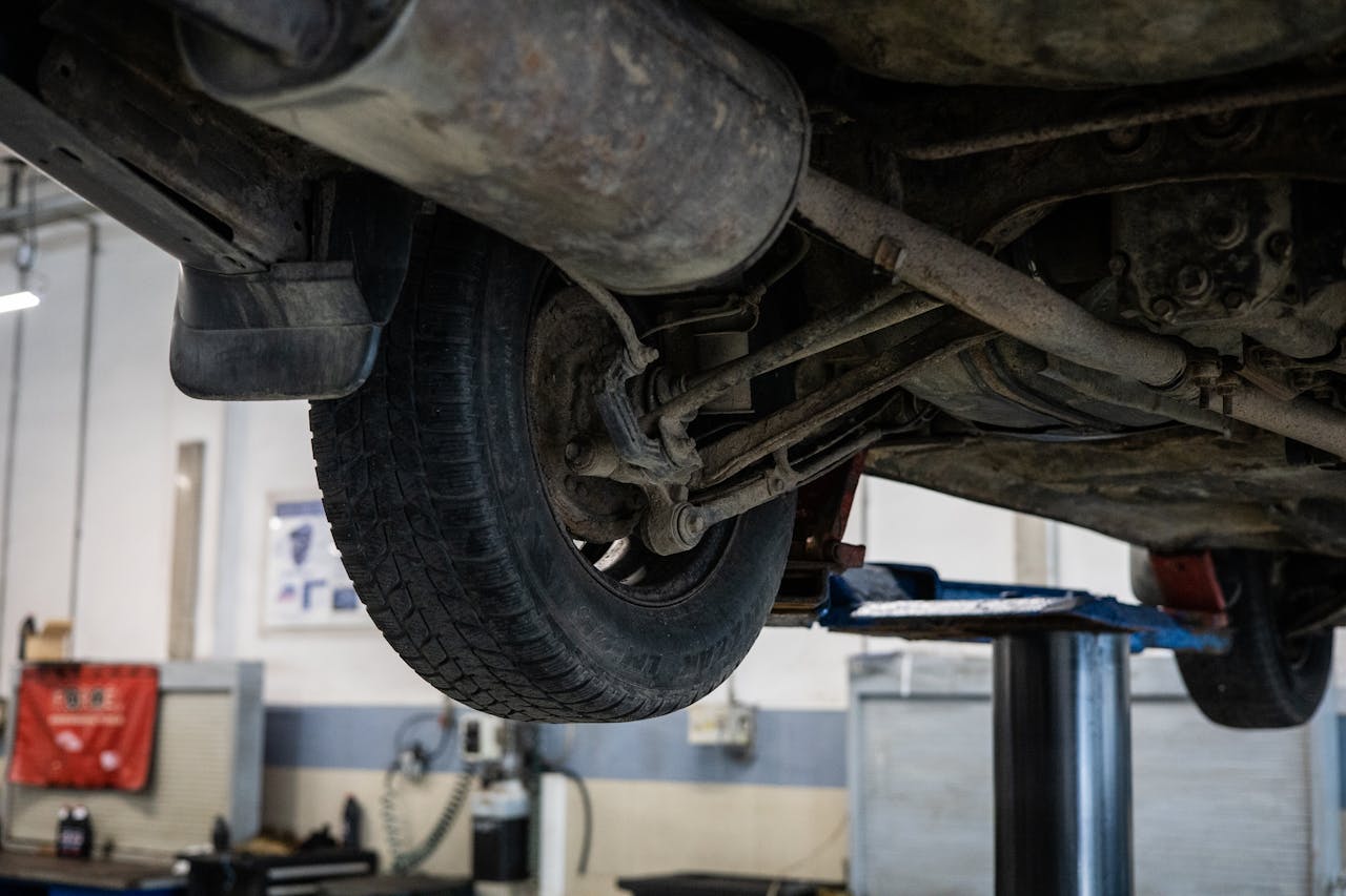 Close-up of car's undercarriage in a service station for repair and maintenance.